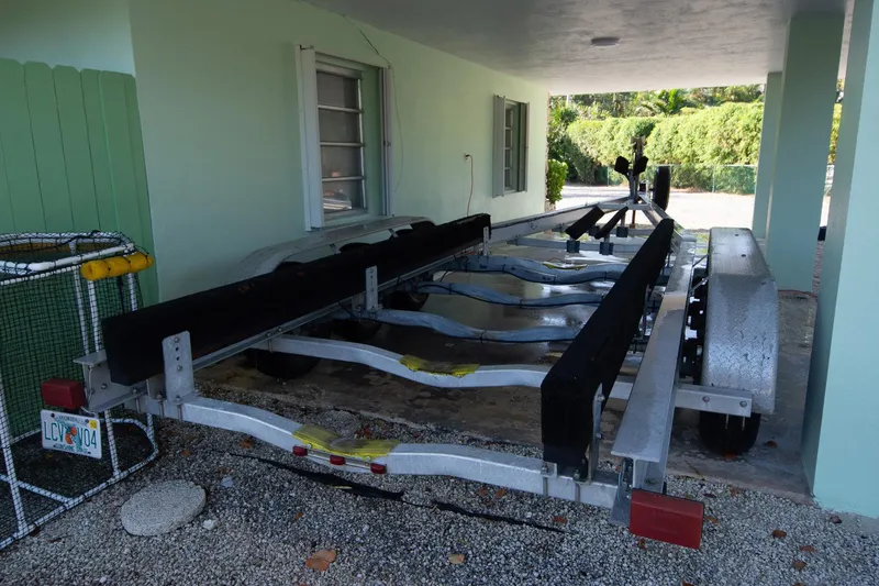 Slide: The Image of Boat trailer parked under a covered area, designed for a 1997 Jupiter 31 Open. - 40