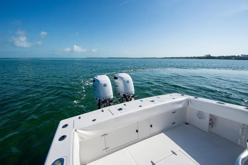 Slide: The Image of 1997 Jupiter 31 Open boat with twin engines on calm ocean waters. - 5