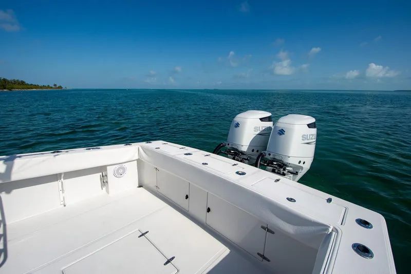 Slide: The Image of 1997 Jupiter 31 Open boat with dual outboard motors on calm ocean water. - 6