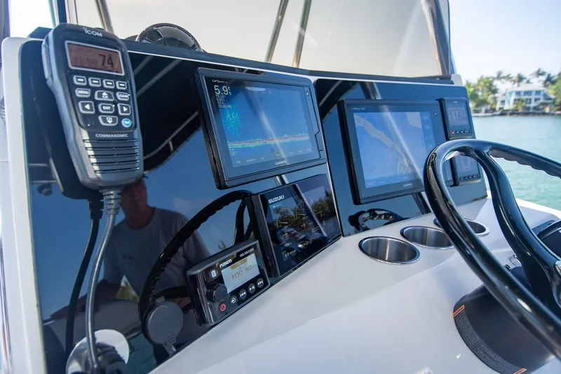 Slide: The Image of Control panel of a 1997 Jupiter 31 Open boat with navigation screens and radio. - 7