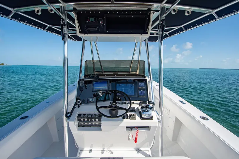 Slide: The Image of 1997 Jupiter 31 Open boat helm with modern controls, navigating clear blue waters. - 9