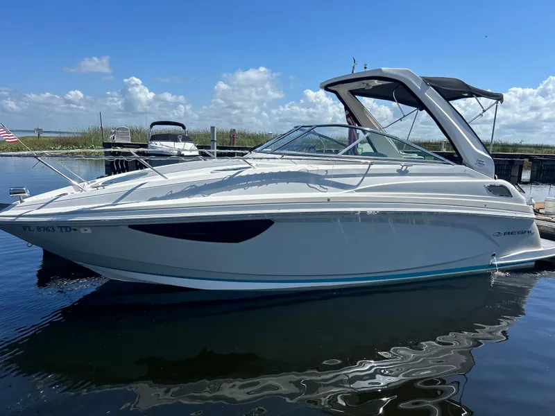 The Image of 2022 Regal 28 Express boat docked on a sunny day with clear skies. - 0