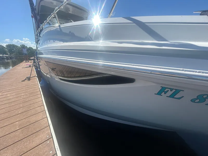 Slide: The Image of 2022 Regal 28 Express boat docked under bright sunlight. - 10