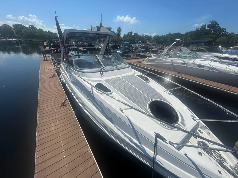 Slide: The Image of 2022 Regal 28 Express boat docked at marina under clear blue sky. - 11
