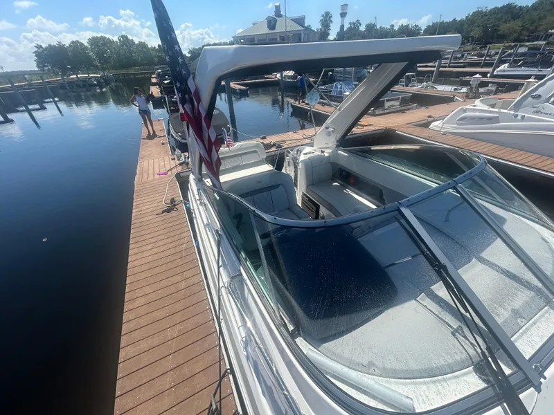 Slide: The Image of 2022 Regal 28 Express boat docked at marina under sunny skies. - 12