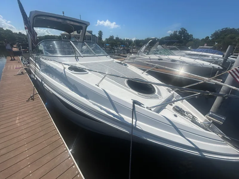 Slide: The Image of 2022 Regal 28 Express boat docked at marina under clear blue sky. - 13
