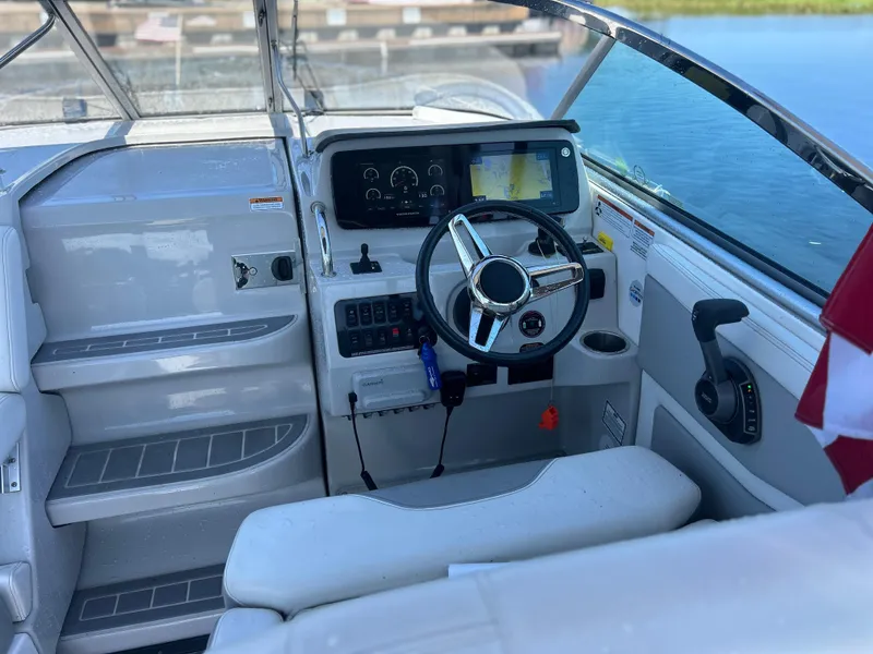 Slide: The Image of 2022 Regal 28 Express boat cockpit with steering wheel and control panel. - 15