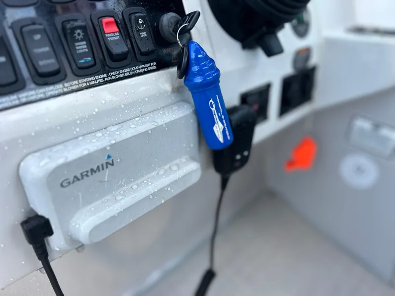 Slide: The Image of Control panel of a 2022 Regal 28 Express boat with Garmin device. - 19