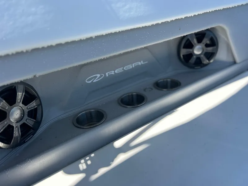 Slide: The Image of 2022 Regal 28 Express boat speakers and cup holders in close-up view. - 20