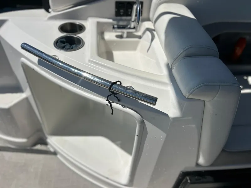 Slide: The Image of 2022 Regal 28 Express boat interior with sink and cup holders. - 24