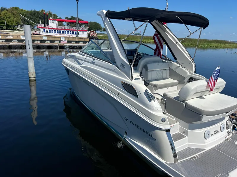 Slide: The Image of 2022 Regal 28 Express boat docked, featuring sleek design and American flags. - 3