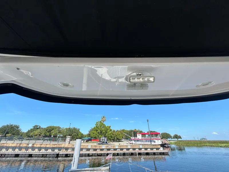 Slide: The Image of 2022 Regal 28 Express boat view from interior, overlooking marina and docked boats. - 31