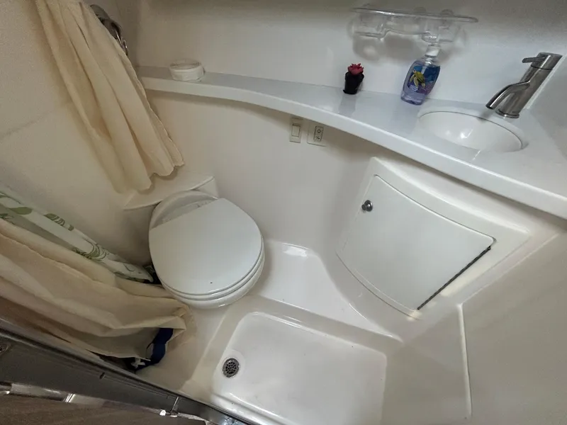 Slide: The Image of 2022 Regal 28 Express bathroom with shower, sink, and toilet in compact layout. - 32