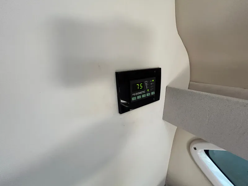 Slide: The Image of Thermostat control panel inside 2022 Regal 28 Express boat cabin. - 33