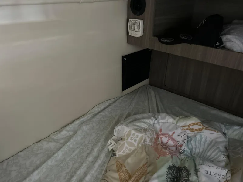 Slide: The Image of 2022 Regal 28 Express cabin interior with bedding and storage area. - 35