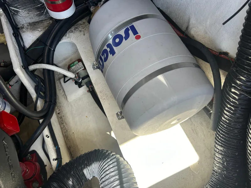 Slide: The Image of Engine compartment of a 2022 Regal 28 Express boat with Isotemp water heater. - 42