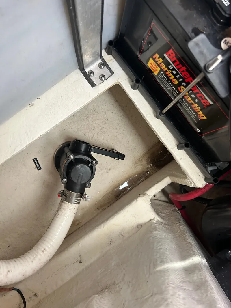 Slide: The Image of 2022 Regal 28 Express boat bilge area with pump and marine battery. - 43