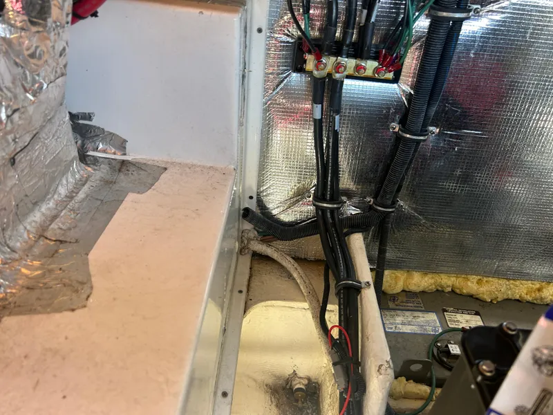 Slide: The Image of Engine compartment of a 2022 Regal 28 Express boat, showing wiring and insulation. - 44