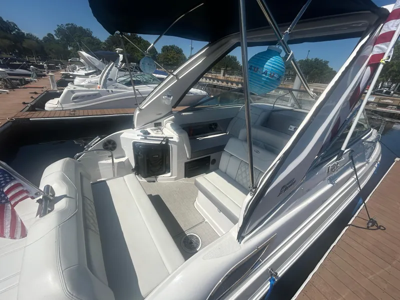 Slide: The Image of 2022 Regal 28 Express boat docked, featuring spacious seating and sleek design. - 5