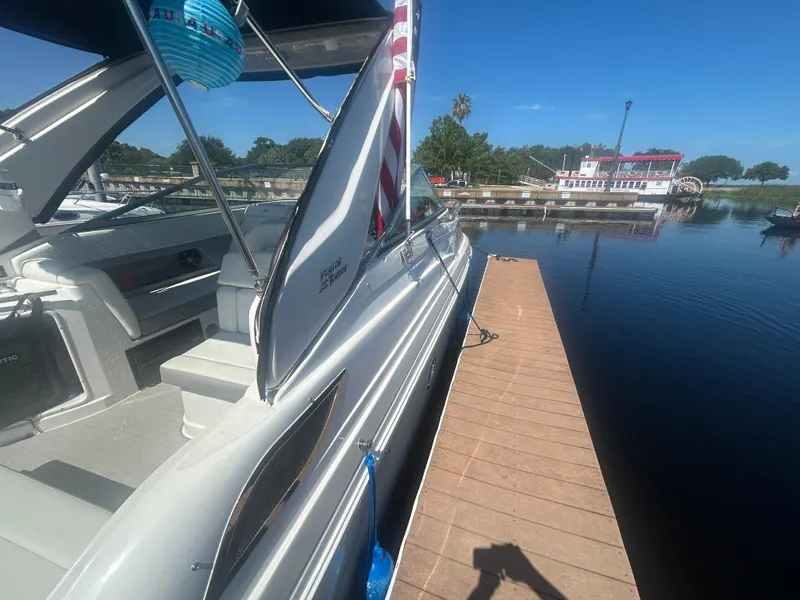 Slide: The Image of 2022 Regal 28 Express boat docked by a serene waterfront. - 6