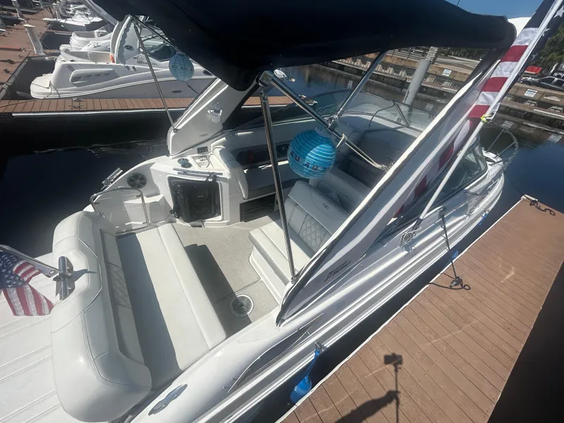 Slide: The Image of 2022 Regal 28 Express boat docked, featuring spacious seating and canopy. - 7