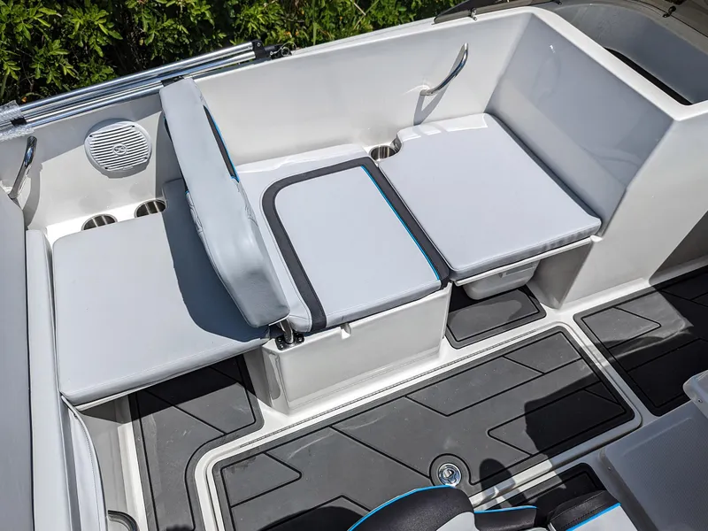 Slide: The Image of 2024 Bayliner Element M19 boat interior with gray seating and storage compartments. - 18