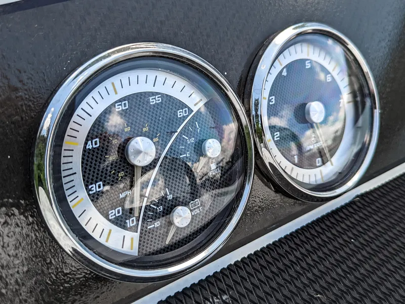 Slide: The Image of 2024 Bayliner Element M19 dashboard gauges close-up, featuring speedometer and tachometer. - 22