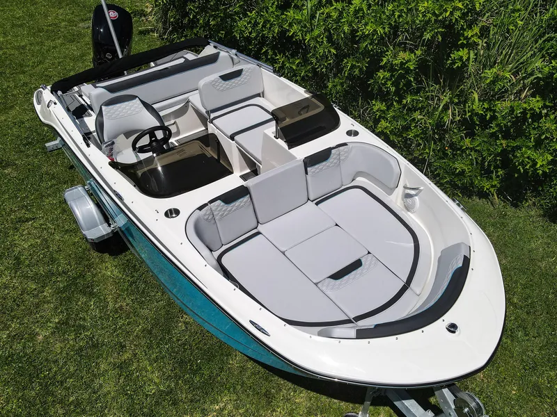 Slide: The Image of 2024 Bayliner Element M19 boat on grass, showcasing spacious seating and sleek design. - 25