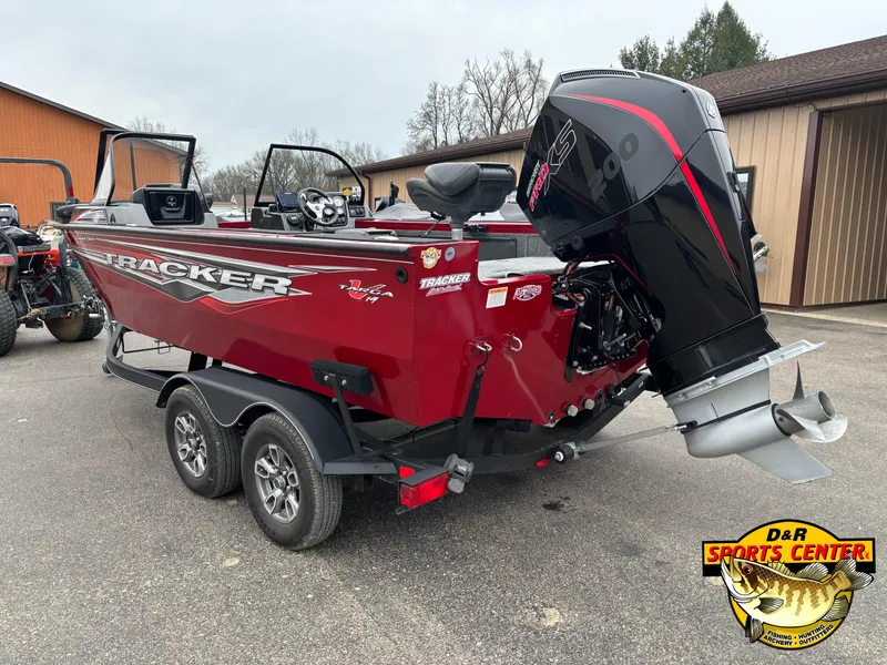 Slide: The Image of 2021 Tracker Targa V-19 WT Tournament Edition boat with powerful outboard motor, parked outdoors. - 3