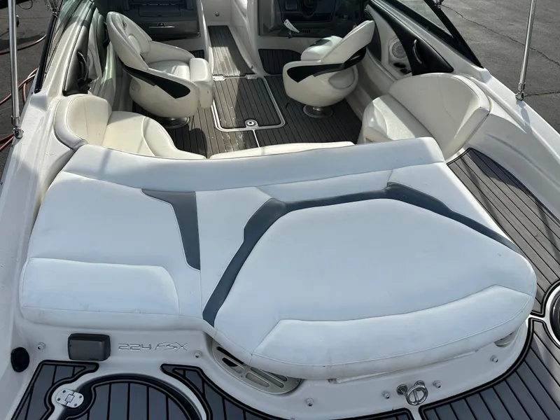 Slide: The Image of 2013 Monterey 224FXS boat interior with white seating and sleek design. - 5