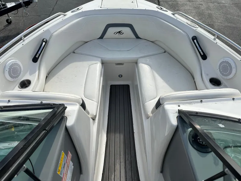 Slide: The Image of 2013 Monterey 224FXS boat interior with white seating and black accents. - 7