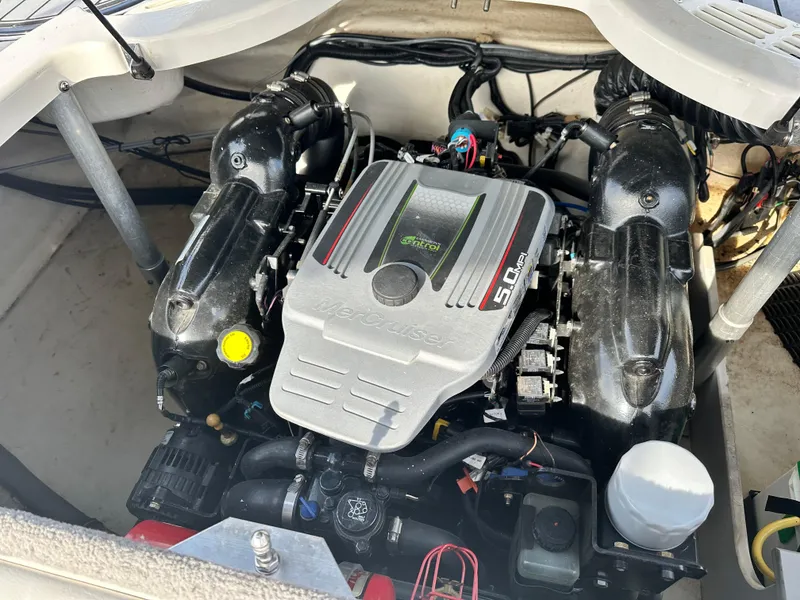 Slide: The Image of Engine compartment of a 2013 Monterey 224FXS boat, featuring a powerful 5.0L engine. - 9