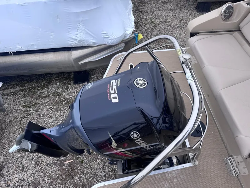 Slide: The Image of Yamaha 250 outboard motor on 2014 Godfrey AP240EL3 boat, docked on gravel. - 12
