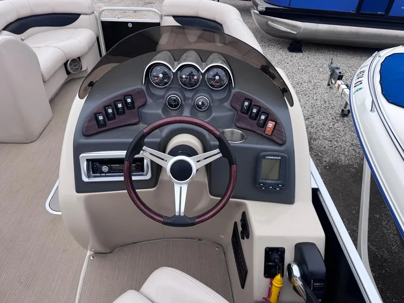 Slide: The Image of Steering console of a 2014 Godfrey AP240EL3 boat with gauges and controls. - 9