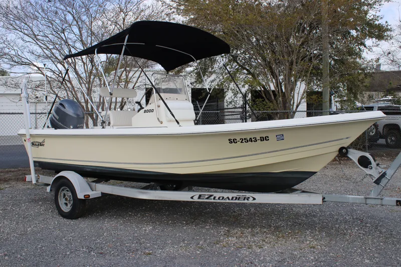 Slide: The Image of 2015 Bulls Bay 2000 boat on EZ Loader trailer with canopy, parked outdoors. - 0