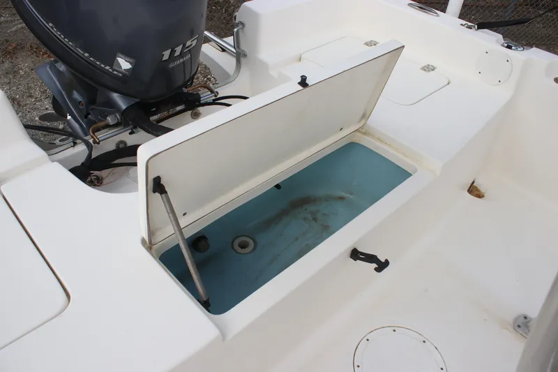 Slide: The Image of 2015 Bulls Bay 2000 boat with open storage compartment and visible outboard motor. - 11