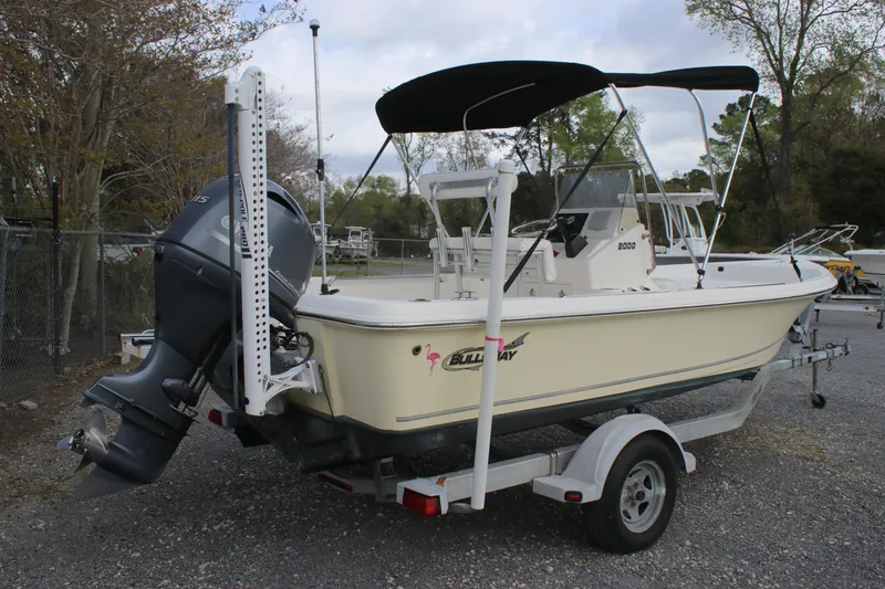 Slide: The Image of 2015 Bulls Bay 2000 boat on trailer with canopy, parked outdoors. - 2