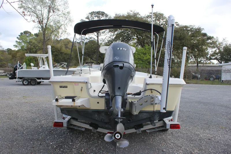Slide: The Image of 2015 Bulls Bay 2000 boat with outboard motor, parked on a trailer in a lot. - 3