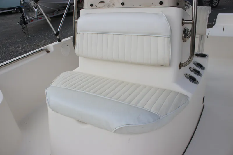 Slide: The Image of White seating on a 2015 Bulls Bay 2000 boat, featuring cushioned upholstery and cup holders. - 6