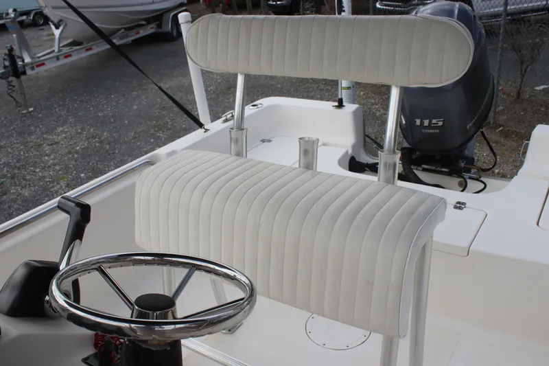 Slide: The Image of 2015 Bulls Bay 2000 boat interior with steering wheel and cushioned seating. - 7