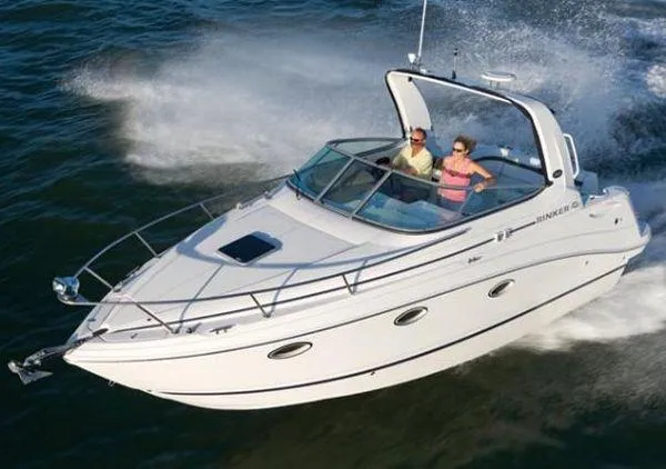 The Image of 2008 Rinker 260 EC boat cruising on water with two passengers. - 1
