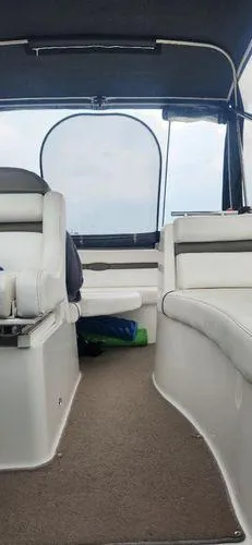 Slide: The Image of 2008 Rinker 260 EC boat interior with white seating and carpeted floor. - 10