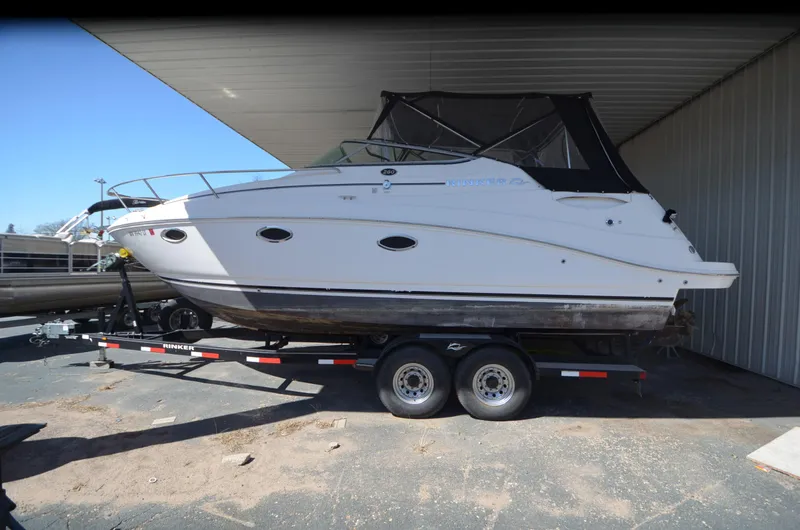 Slide: The Image of 2008 Rinker 260 EC boat on trailer under shelter. - 11