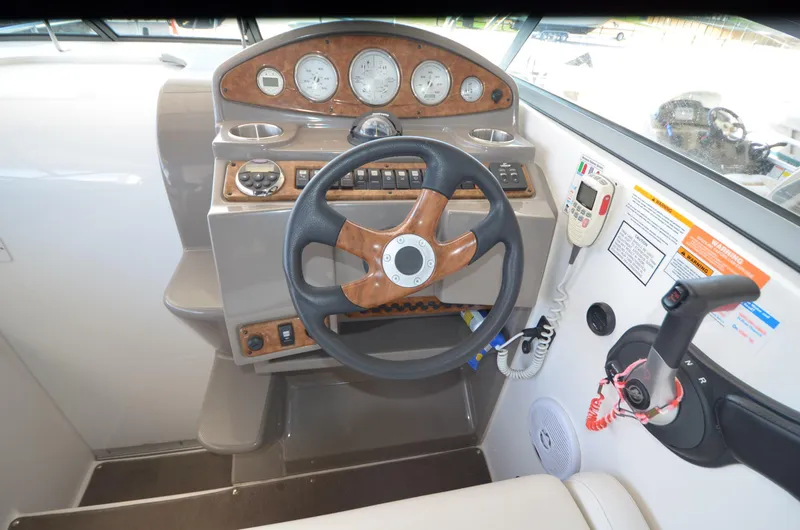 Slide: The Image of 2008 Rinker 260 EC boat dashboard with steering wheel and control panel. - 13
