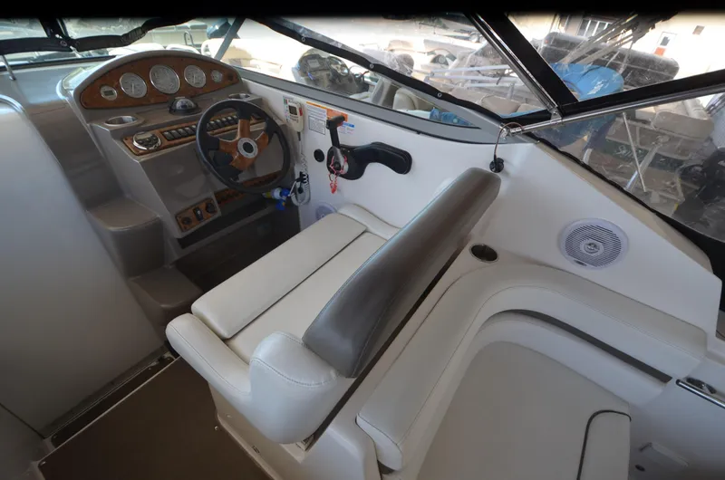 Slide: The Image of 2008 Rinker 260 EC boat interior with steering wheel and seating area. - 14