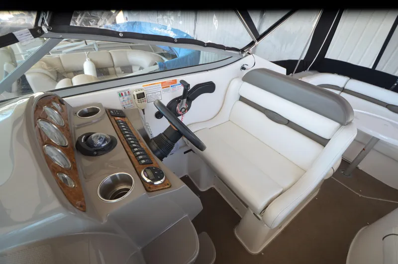 Slide: The Image of Interior of 2008 Rinker 260 EC boat showing helm and seating area. - 17