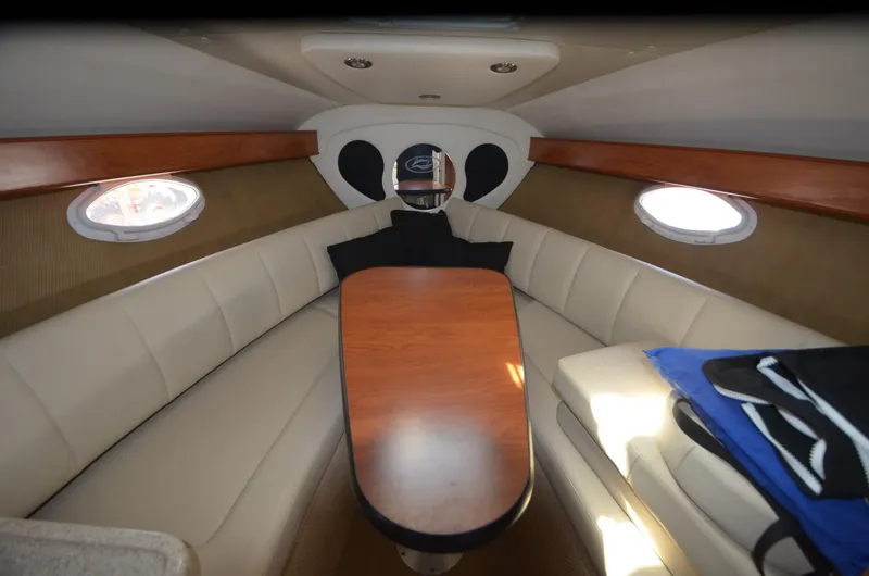 Slide: The Image of Interior cabin of 2008 Rinker 260 EC boat with seating and table. - 19