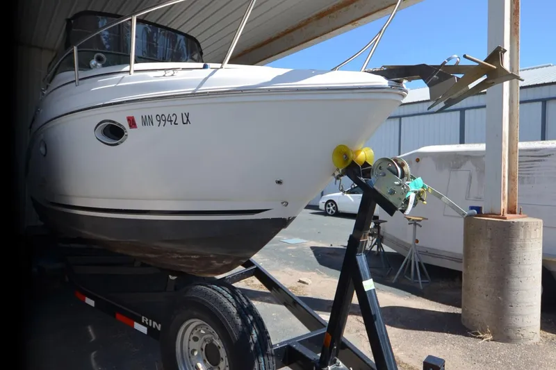 Slide: The Image of 2008 Rinker 260 EC boat on trailer in covered storage area. - 22