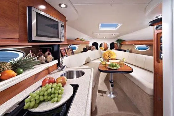 Slide: The Image of Luxurious interior of a 2008 Rinker 260 EC boat with modern amenities and elegant seating. - 3