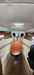 Slide: The Image of Interior of a 2008 Rinker 260 EC boat with seating and table. - 8